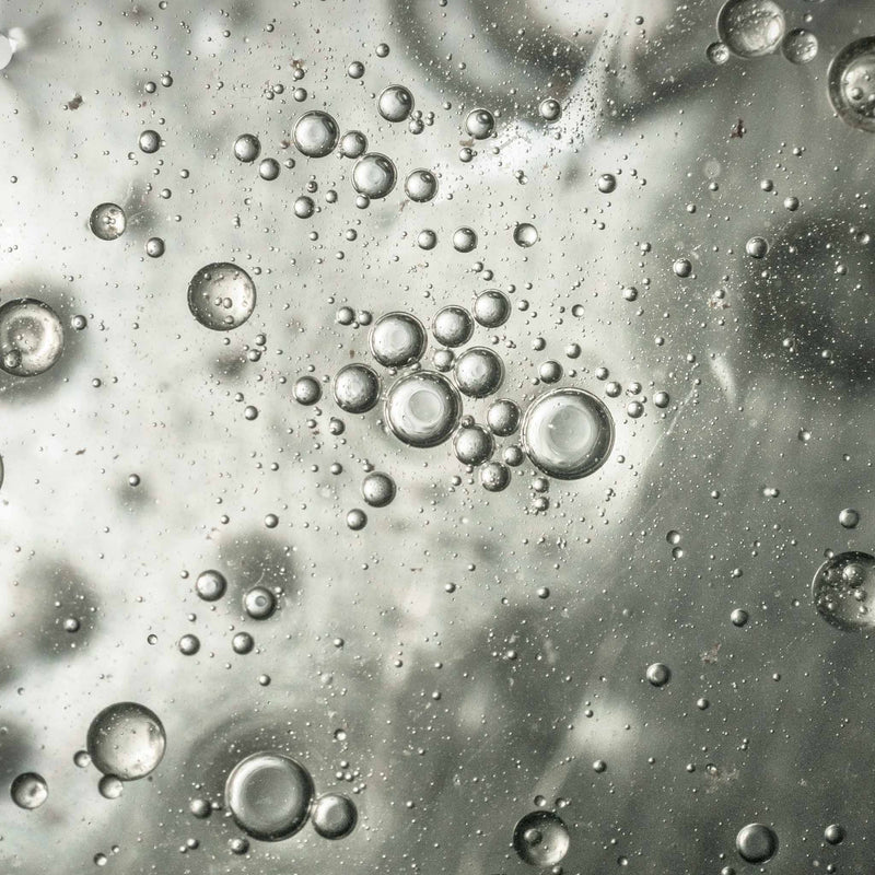 Close-up of liquid bubbles on a gray background