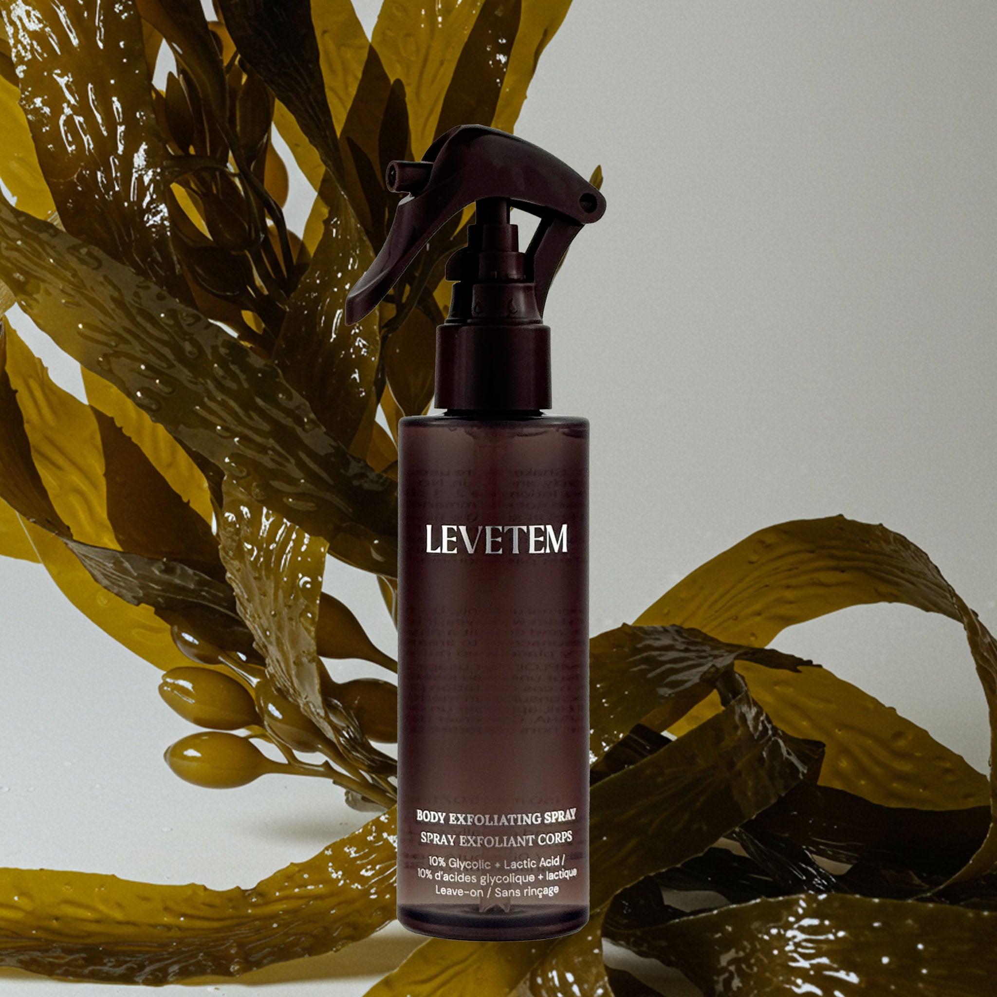 Levetem body exfoliating spray bottle with seaweed on a light gray background
