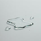 Close-up of droplets Levetem body exfoliating liquid exfoliator on a gray surface
